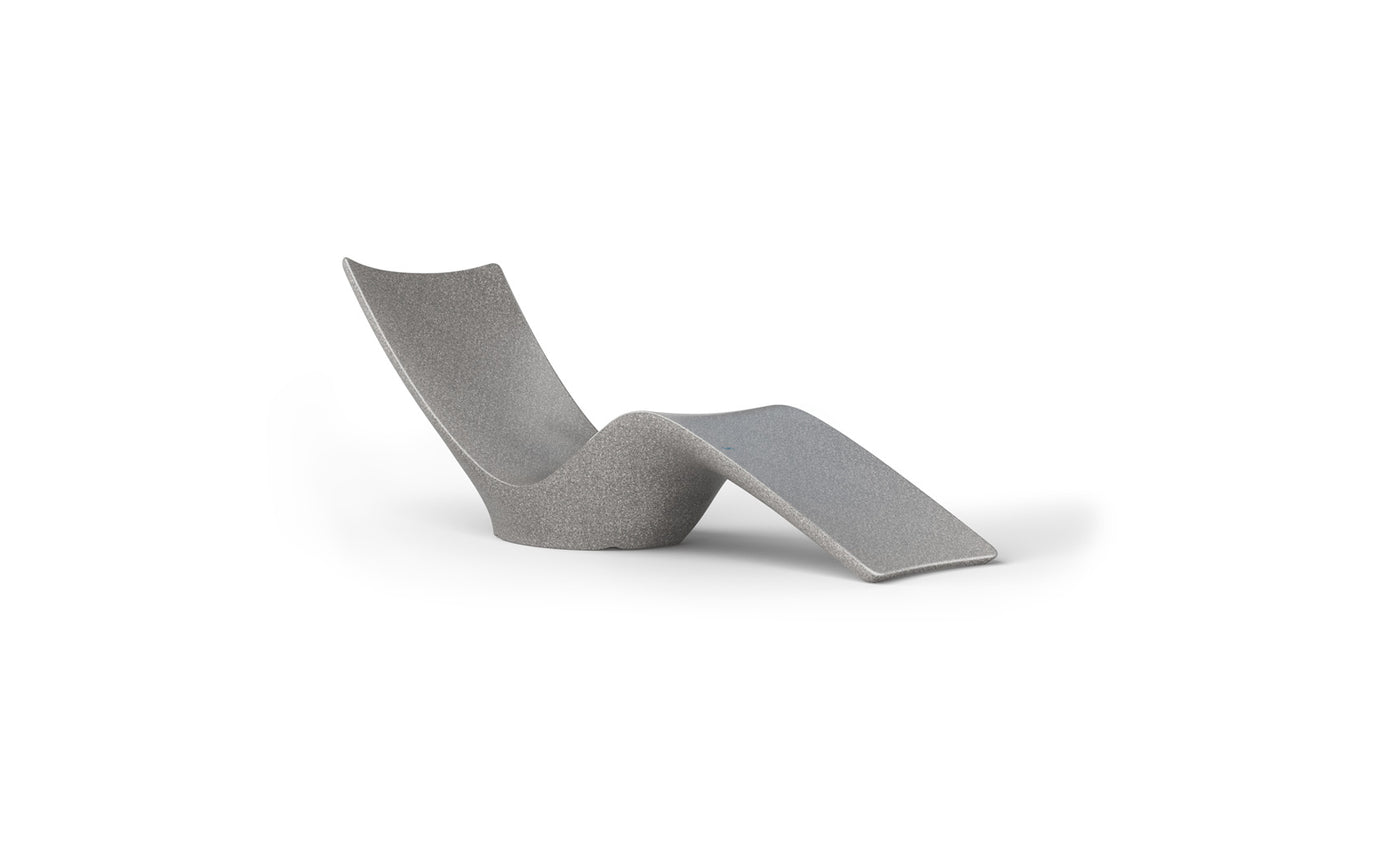 The Autograph Chaise from Ledge Lounger is a sleek, minimalist gray design with smooth curves that enhance comfort, making it ideal for both indoor relaxation and transforming outdoor spaces into serene retreats.