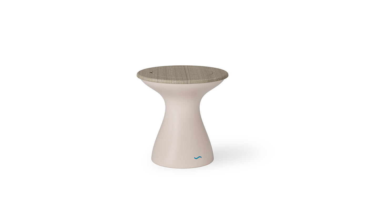 The Autograph Tall Ice Bin Side Table by Ledge Lounger features a modern, hourglass design with a beige body and textured wooden top. A small blue wave logo adorns the base, making it versatile for any setting, from a white background to seamlessly blending into your patio decor.