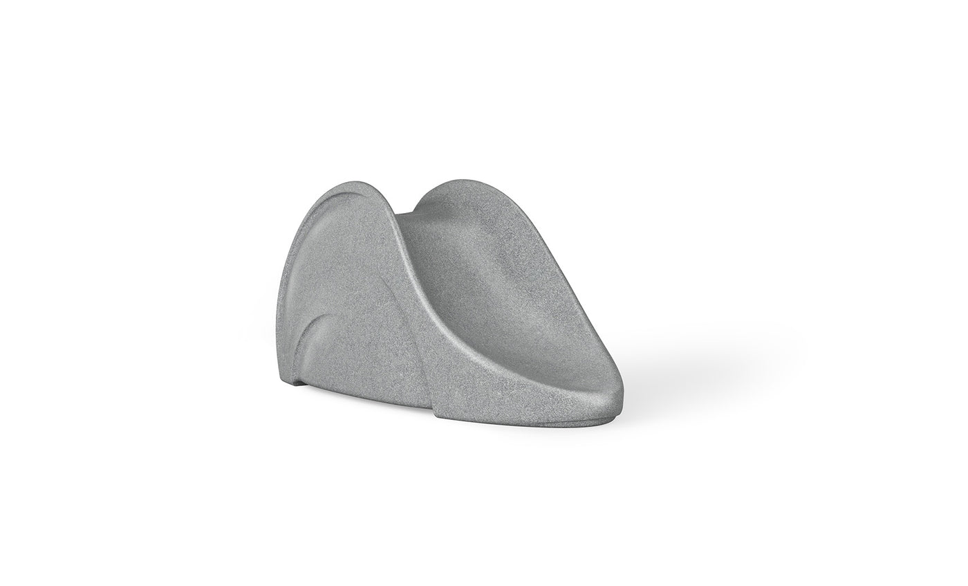 A minimalist, curved gray Signature Slide by Ledge Lounger resembling an abstract sculpture on a plain white background.