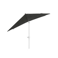 The 8.5 Square Signature 360° Tilt Umbrella by Ledge Lounger, featuring an angled dark green shade and white pole, is displayed against a plain white backdrop, embodying resort luxury.