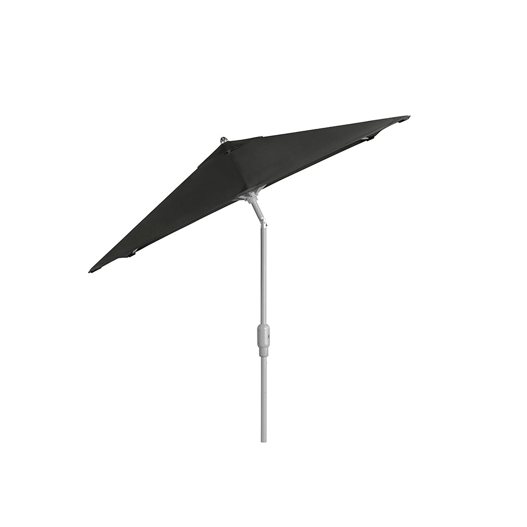 The Ledge Lounger 6.5 Square Signature 360° Tilt Umbrella, in black, showcases a minimalist design with a slender vertical pole angled left. Its rustproof frame ensures durability against the elements.