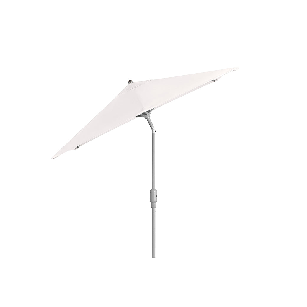 The 6.5 Square Signature 360° Tilt Umbrella by Ledge Lounger features a sleek, silver pole and rustproof frame. Its white canopy tilts adjustably, combining durability with elegance against a plain backdrop.