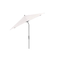 The 6.5 Square Signature 360° Tilt Umbrella by Ledge Lounger features a sleek, silver pole and rustproof frame. Its white canopy tilts adjustably, combining durability with elegance against a plain backdrop.