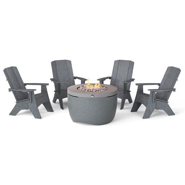 The Halo Aglow Bundle by Ledge Lounger features four dark gray Adirondack chairs around a round gray outdoor gas fire pit, embellished with small stones and a gentle central flame, set against a plain white background.