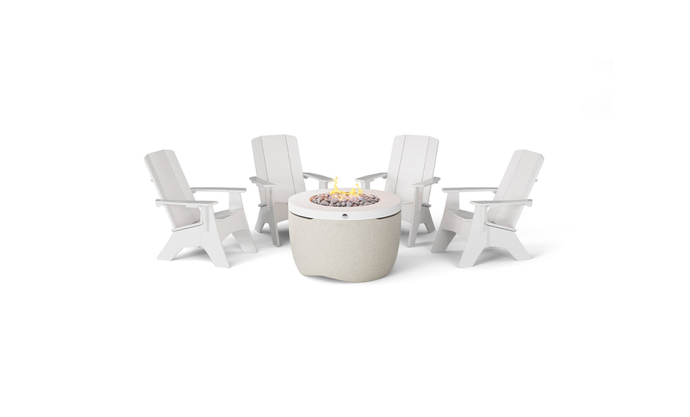The Halo Aglow Bundle by Ledge Lounger features four white Adirondack chairs encircling a gray round fire pit table, complete with a burning flame and decorative stones, all set against a plain white backdrop.