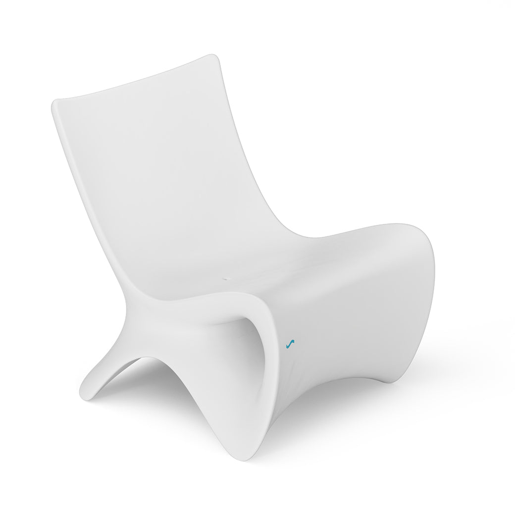 The Autograph Chair by Ledge Lounger is a modern, uniquely designed white luxury lounger featuring smooth, flowing curves and no armrests, showcased against a plain white background.