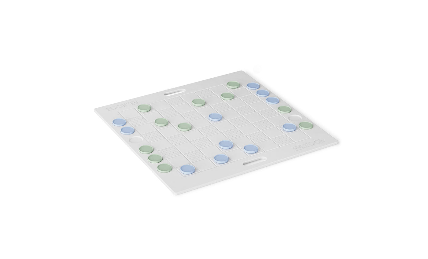 The Ledge Lounger Checkers & Tic Tac Toe board features a white checkered design with green and blue pieces. The grid pattern and side handles suggest a setup perfect for strategic abstract or giant lawn games.