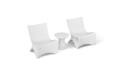 Two Classic Luxury In-Pool Chair Duo pieces by Ledge Lounger, with a small matching side table on a white background, showcase sleek, minimalist design and gentle curves—ideal for contemporary spaces.
