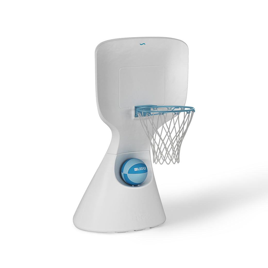 The Hoopstr by Ledge Lounger is a modern, white poolside basketball stand perfect for family fun. It features a compact, minimalist design with a smooth backboard, blue-railed hoop and net, and an easily repositionable base with a blue circular detail.