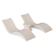 The Ledge Lounger Outdoor Oasis In-Pool Furniture Bundle includes a modern, sculptural beige lounge chair featuring two curved seats on a circular base. Its sleek design with smooth surfaces and minimalist lines is ideal for creating an artistic outdoor retreat.