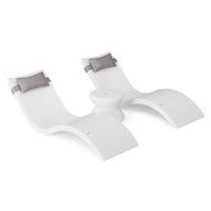 The Ledge Lounger Signature Chaise Headrest Pillow and Side Table In-Pool Set features two modern white loungers with grey headrests, joined by a round side table—an ideal poolside upgrade for your outdoor space, shown on a white background.