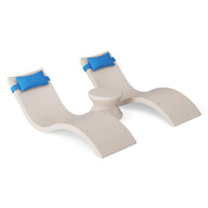The Ledge Lounger Signature Chaise Headrest Pillow and Side Table In-Pool Set features two beige chaise loungers with blue headrest pillows and a matching round side table, displayed on a white background.