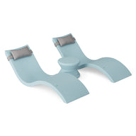 The Ledge Lounger Signature Chaise Headrest Pillow and Side Table In-Pool Set features two modern light blue lounge chairs with headrests and a central round table, ideal pool ledge furniture for your outdoor paradise, shown on a plain white background.