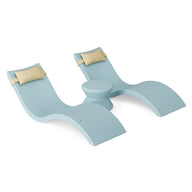 The Ledge Lounger Signature Chaise Headrest Pillow and Side Table In-Pool Set features two light blue curved chaise loungers with beige headrests, joined by a round side table, creating stylish pool ledge furniture.