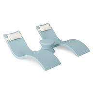 The Ledge Lounger Signature Chaise Headrest Pillow and Side Table In-Pool Set features two curved seats with white headrests and a central side table—ideal pool ledge furniture for your outdoor oasis.