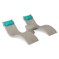 The Ledge Lounger Signature Chaise Headrest Pillow and Side Table In-Pool Set features two beige curved lounge chairs with turquoise headrests, joined by a round side table—an ideal, stylish poolside setup for your outdoor paradise.