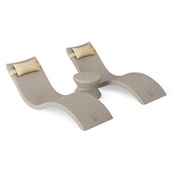 The Ledge Lounger Signature Chaise Headrest Pillow and Side Table In-Pool Set offers two beige curved lounge chairs with light yellow headrests and a small round side table, bringing modern minimalistic style to your poolside relaxation.