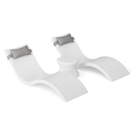 The Ledge Lounger Signature Chaise Headrest Pillow and Side Table In-Pool Set features two modern white chaises with light gray headrests and a round table, offering sleek poolside comfort and transforming any plain white space into a stylish retreat.