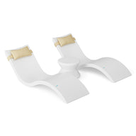 The Ledge Lounger Signature Chaise Headrest Pillow and Side Table In-Pool Set features two modern white seats with beige headrests, connected by a round side table—ideal minimalistic loungers for your outdoor paradise.