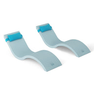 The Outdoor Escape In-Pool Furniture Bundle by Ledge Lounger includes two light blue, wave-shaped foam chaise lounges with headrest pillows, ideal for outdoor pool settings. Their sleek, contoured design is perfect for floating on water and is showcased against a pristine white background.