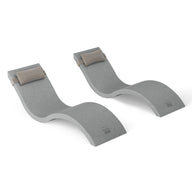 The Outdoor Escape In-Pool Furniture Bundle by Ledge Lounger features two chic, wave-shaped gray reclining loungers with cushioned headrests, set against a white backdrop. Ideal for ultimate comfort, these stylish chaise lounges complement any modern outdoor furniture collection.