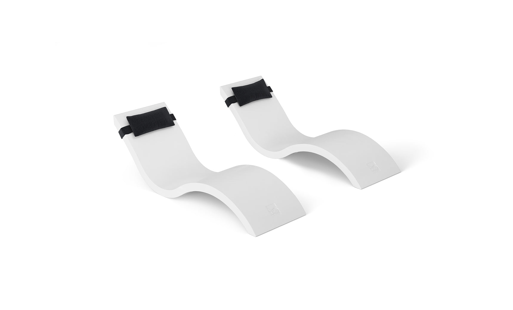A pair of stylish outdoor Signature Chaise lounge chairs from Ledge Loungers Outdoor Escape In-Pool Furniture Bundle, featuring sleek curves and black headrest pillows, rest against a white background, promising ultimate relaxation in style.