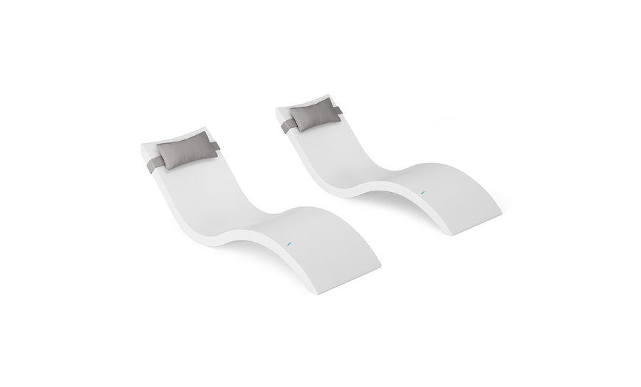 Two Signature Chaise and Headrest Pillow In-Pool Sets by Ledge Lounger, featuring a sleek wave-like design in modern white with gray pillows, are displayed side by side on a white background—perfect for stylish outdoor lounging.