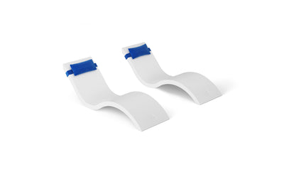 The Outdoor Escape In-Pool Furniture Bundle by Ledge Lounger features two modern, white S-shaped chaise lounge chairs with curved designs and blue headrest pillows, displayed on a plain white background.