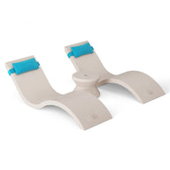 The Ledge Lounger Outdoor Paradise In-Pool Furniture Bundle features two beige, curved yoga blocks connected by a central joint with blue padding on top for comfort, offering an ergonomic design for varied positioning during exercise or stretching routines.