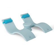 The Ledge Lounger Outdoor Paradise In-Pool Furniture Bundle features a modern, ergonomic light blue plastic chair with a wavy design, two leg sections, and a central seat topped with blue cushions—perfect for in-pool chaise lounging and complementing your pool ledge furniture.