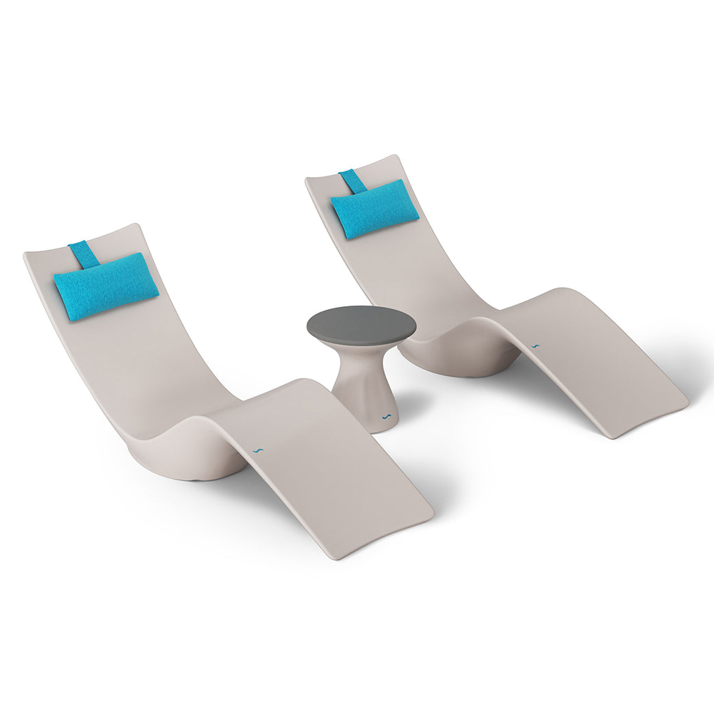 Ledge Loungers Resort Luxury Outdoor Paradise In-Pool Furniture Bundle includes two modern white chaise loungers with blue headrests and a small round table, arranged on a plain white backdrop for a minimalist, poolside relaxation vibe.
