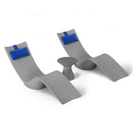 The Resort Luxury Outdoor Paradise In-Pool Furniture Bundle by Ledge Lounger features two modern gray curved chaise loungers with blue cushions, perfectly flanking a small round gray table, creating a stylish poolside look against a plain white backdrop.