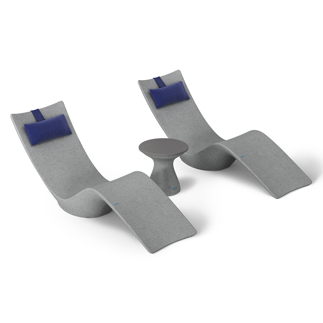 The Ledge Loungers Resort Luxury Outdoor Paradise In-Pool Furniture Bundle includes two modern, curved chaise loungers in light gray with blue headrests and a small, round dark gray side table—offering a sleek and contemporary vibe perfect for poolside relaxation.