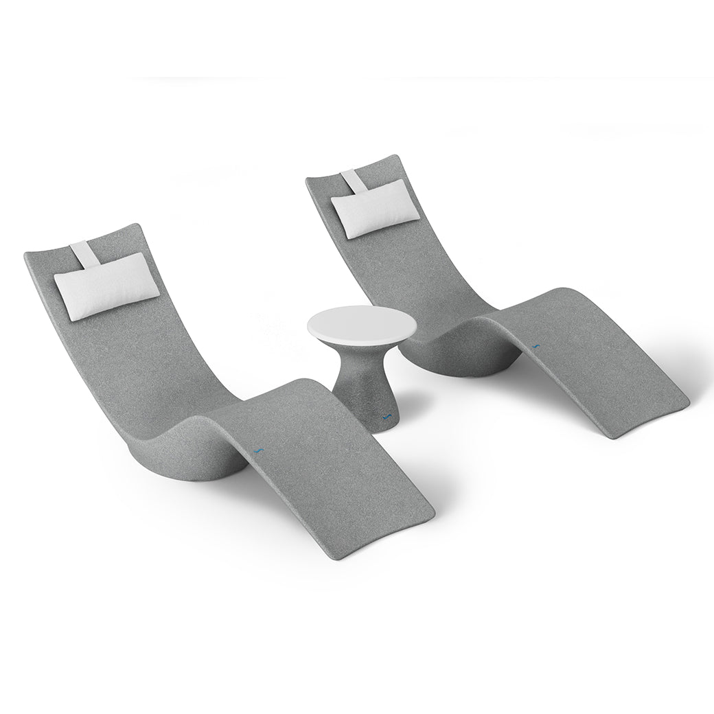 The Ledge Lounger Resort Luxury Outdoor Paradise In-Pool Furniture Bundle includes two modern gray lounge chairs with white cushions flanking a small round white side table. Arranged against a white background, these pieces offer a sleek, minimalist aesthetic perfect for poolside relaxation.