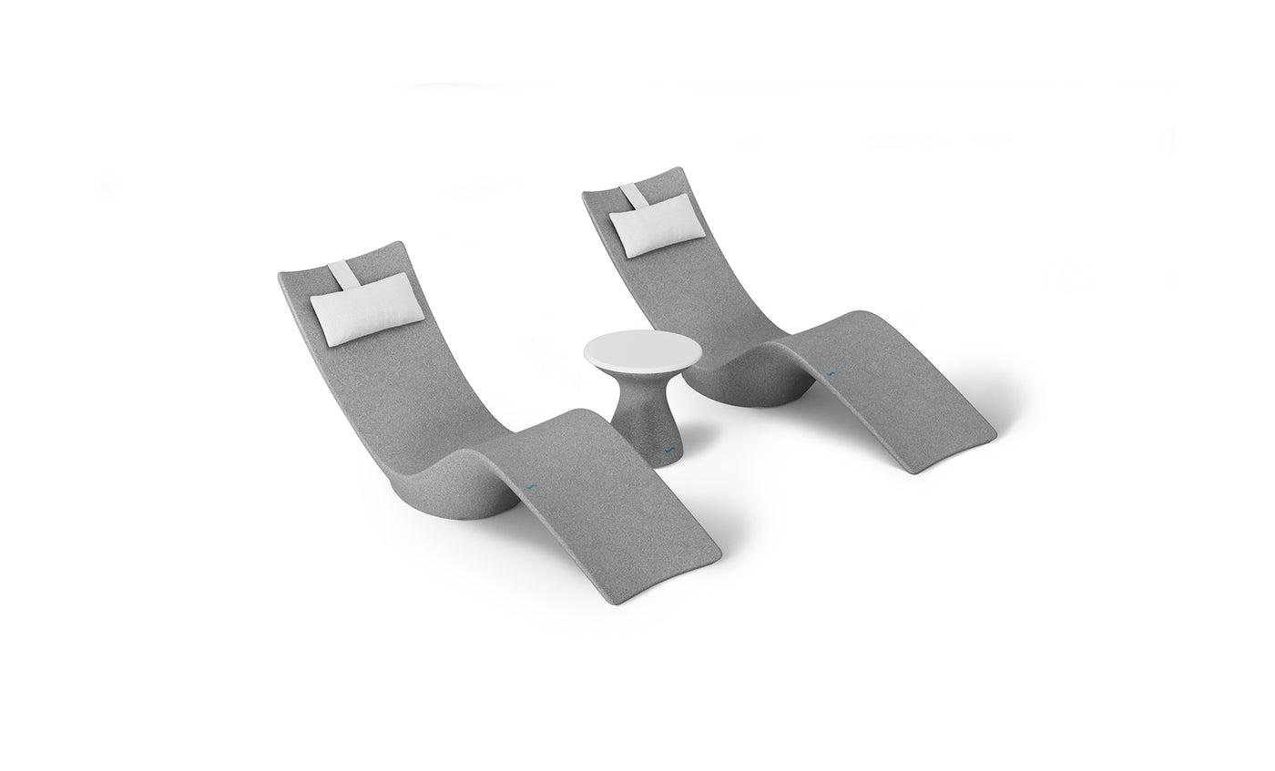 The Ledge Lounger Resort Luxury Outdoor Paradise In-Pool Furniture Bundle includes two modern gray lounge chairs with white cushions flanking a small round white side table. Arranged against a white background, these pieces offer a sleek, minimalist aesthetic perfect for poolside relaxation.