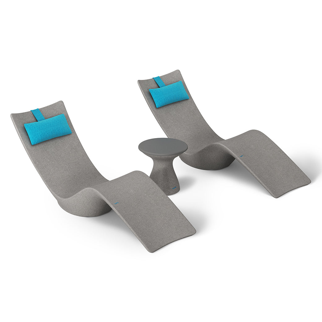 The Ledge Lounger Resort Luxury Outdoor Paradise In-Pool Furniture Bundle includes two modern gray lounge chairs with blue headrests and a small round side table, creating an inviting setup ideal for poolside relaxation or unwinding near the water at home.