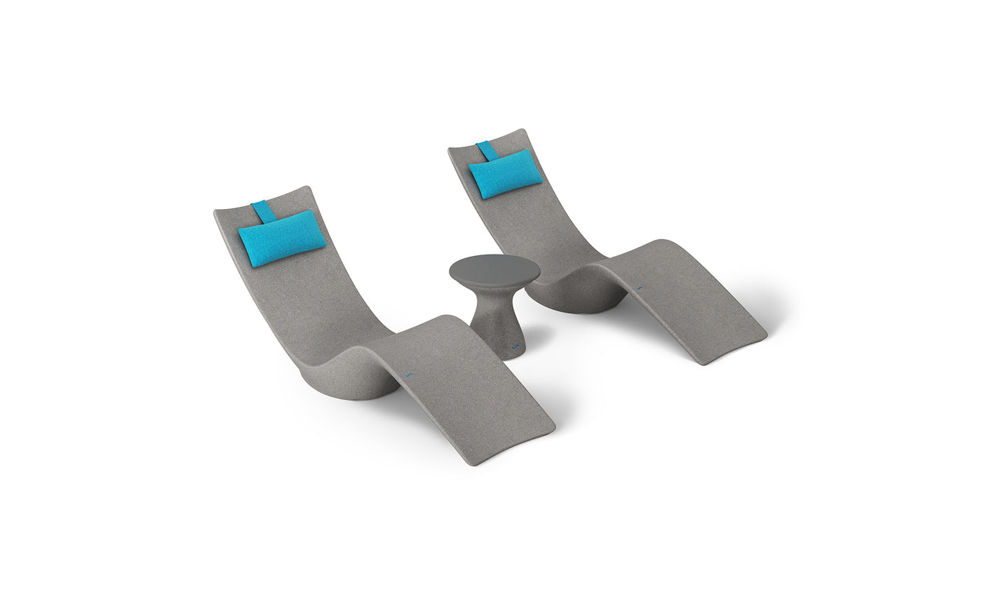 The Ledge Lounger Resort Luxury Outdoor Paradise In-Pool Furniture Bundle includes two modern gray lounge chairs with blue headrests and a small round side table, creating an inviting setup ideal for poolside relaxation or unwinding near the water at home.