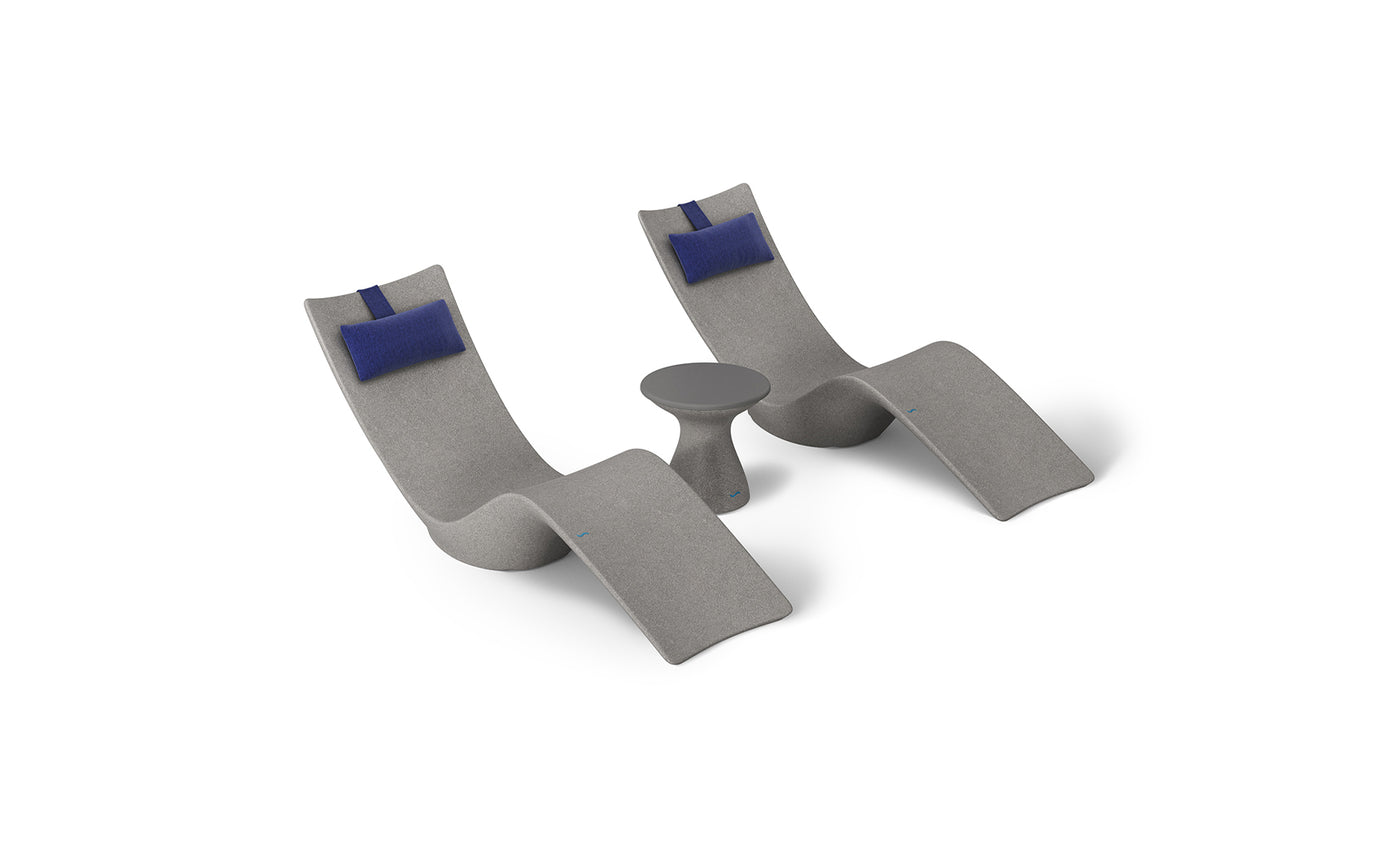 The Resort Luxury Outdoor Paradise In-Pool Furniture Bundle by Ledge Lounger includes two modern gray chaise loungers with blue headrests, paired with a small round gray side table, all designed for sleek poolside relaxation.