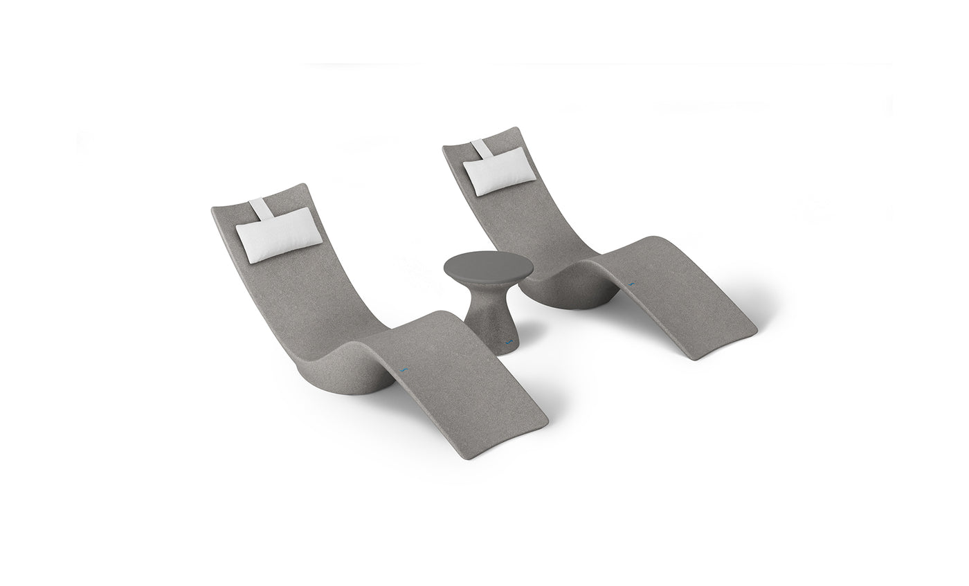 The Resort Luxury Outdoor Paradise In-Pool Furniture Bundle by Ledge Lounger includes two modern gray reclining chaise loungers with white headrest cushions and a small matching gray side table, ideal for poolside relaxation, all set against a plain white background.