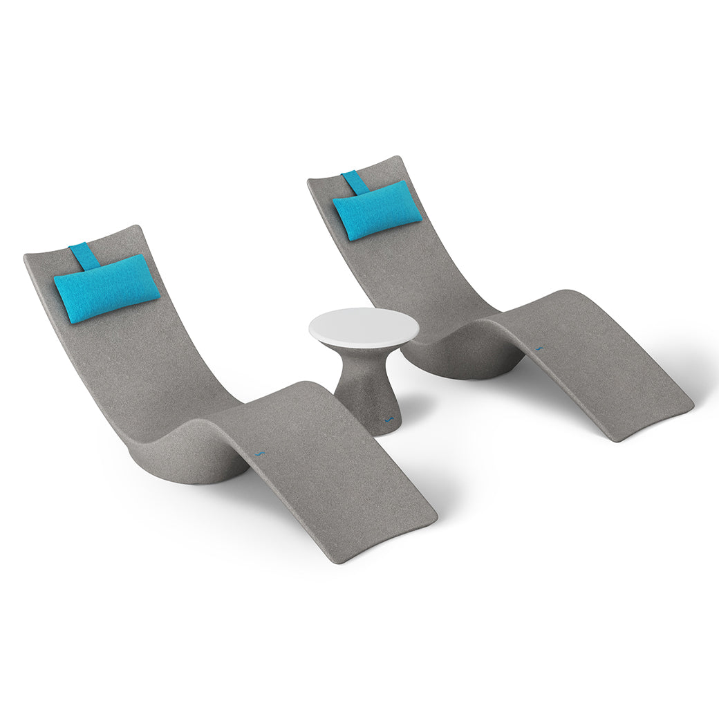 The Ledge Lounger Resort Luxury Outdoor Paradise In-Pool Furniture Bundle includes two modern, curved gray chaise loungers with turquoise cushions and a small round white table, all set against a plain white background—perfect for poolside relaxation.