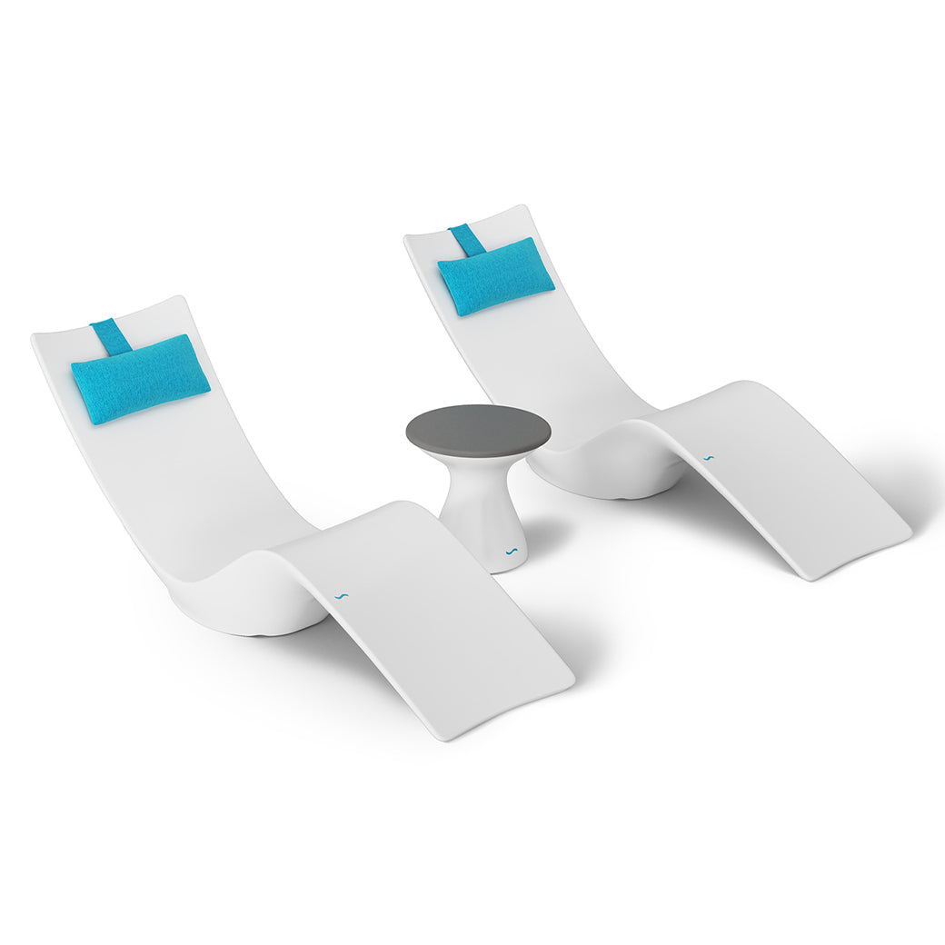 The Ledge Lounger Resort Luxury Outdoor Paradise In-Pool Furniture Bundle features two white chaise loungers with aqua blue headrests flanking a small white side table with a gray top, perfect for poolside relaxation, all set against a plain white background for an elegant look.