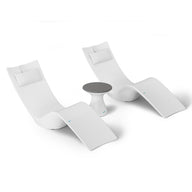 The Ledge Lounger Resort Luxury Outdoor Paradise In-Pool Furniture Bundle includes two modern white lounge chairs with headrests and a small round side table with a dark gray tabletop, ideal for poolside relaxation against a plain, minimalistic backdrop.