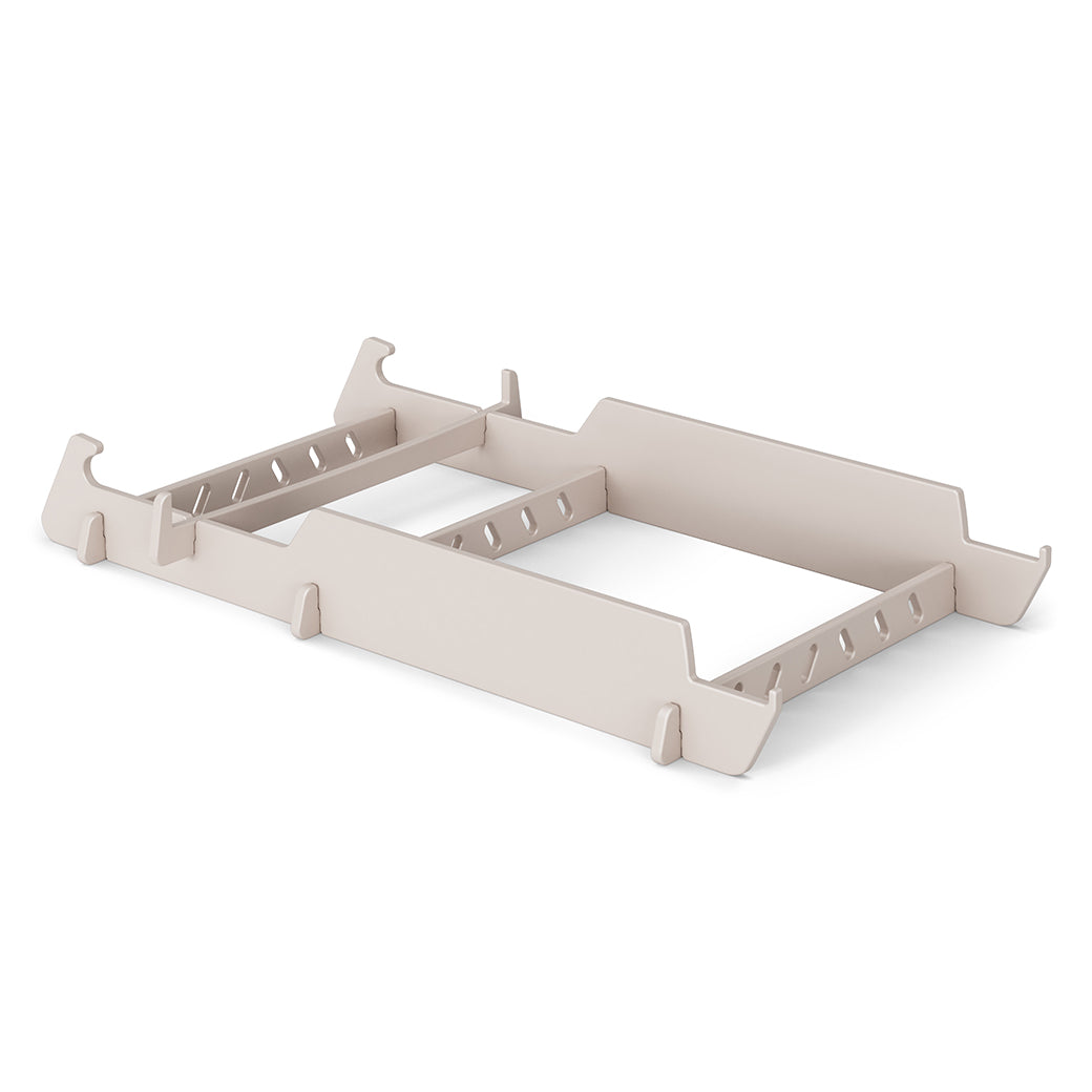 A beige adjustable dividers insert organizes drawers with customizable slots for various items, featuring a sleek design. Like the Signature Lowback Chair Riser by Ledge Lounger, it enhances room style and is elegantly displayed on a plain white background.
