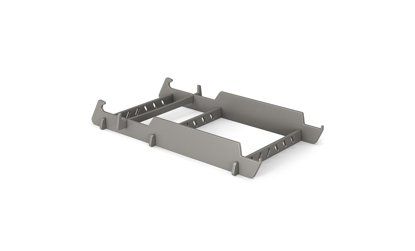 A gray metal server rack mount bracket with angled edges is designed to hold equipment securely, similar to the precision of a Signature Lowback Chair Riser by Ledge Lounger. It features multiple cutouts and slots for adjustable fitting, all set against a white background.