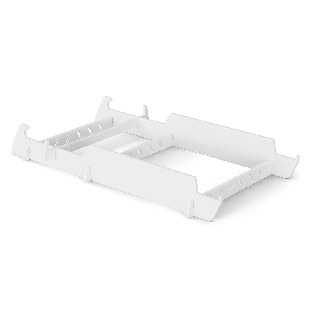 White, rectangular, stackable plastic storage tray with adjustable dividers. Perfect for organizing items in drawers or on shelves, this Ledge Lounger-inspired design adds a touch of elegance to any space.
