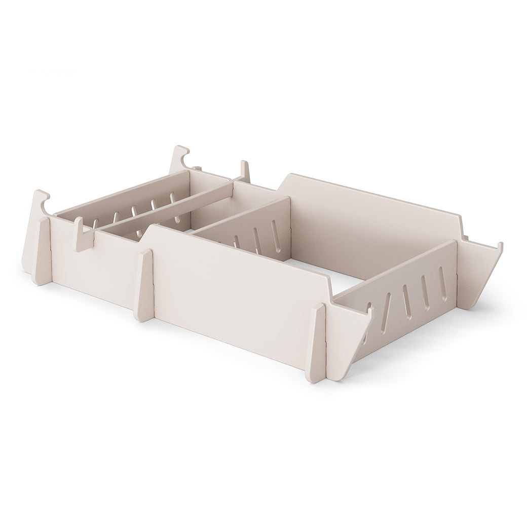 A stylish, beige drawer organizer with adjustable sections and slotted edges for custom compartments, reminiscent of a Signature Lowback Chair Riser by Ledge Lounger, rests elegantly on a plain white background.