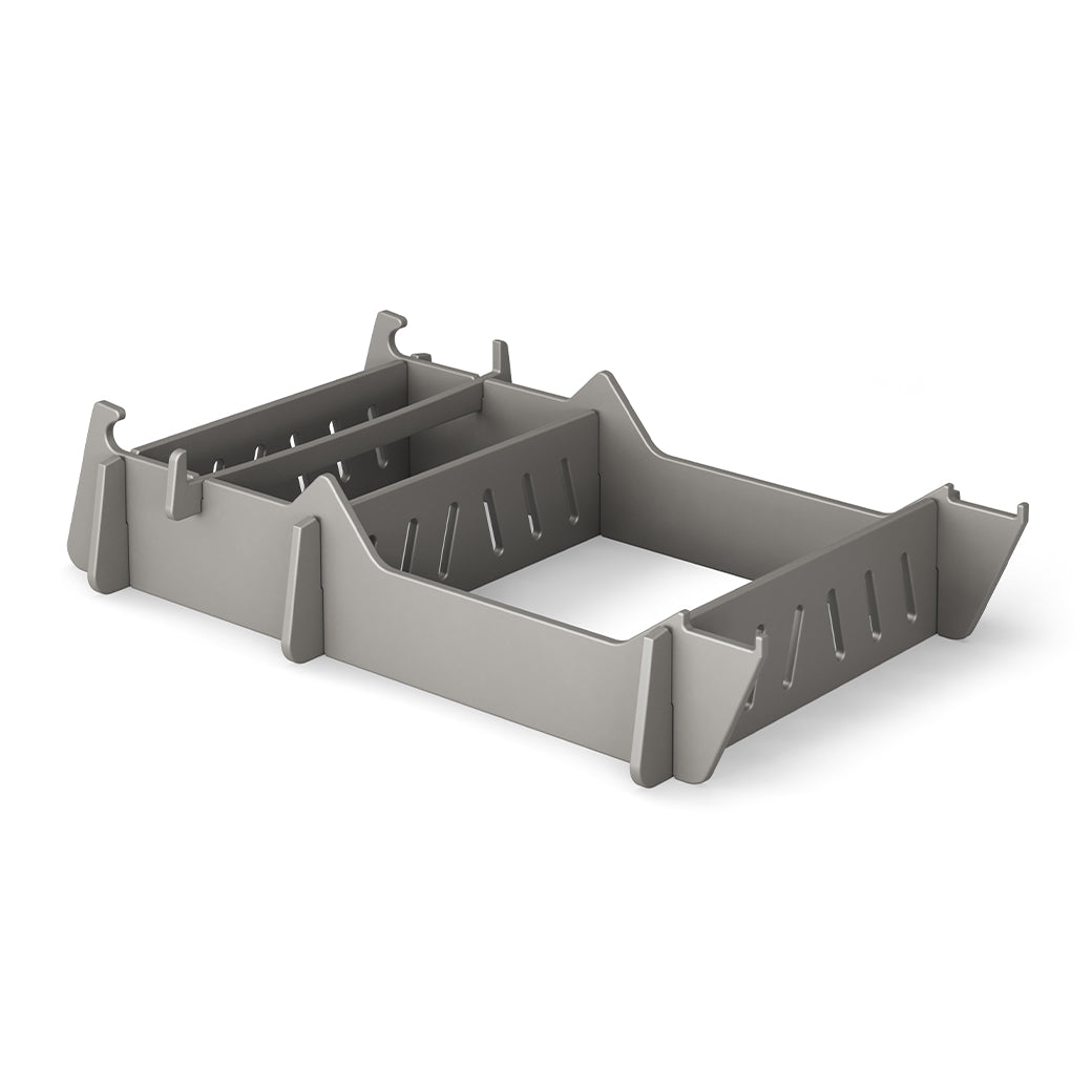 The Signature Chair Riser by Ledge Lounger is a gray, rectangular plastic organizer with vertical dividers and slotted sides, ideal for sorting stationery.