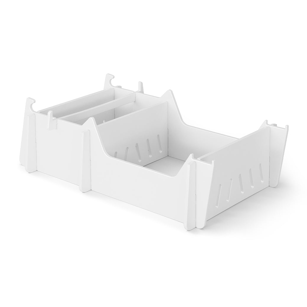A white, rectangular plastic storage box with side handles and slotted walls is angled against a plain white background. Ideal as a Ledge Lounger Signature Chair Riser for organizing poolside essentials outdoors.