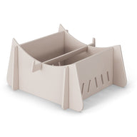 The Ledge Lounger Signature Chaise Riser is a beige modular storage box with interlocking panels, ideal for outdoor essentials. Vertical slots and a central divider create two compartments perfect for organizing in-pool seats or other items.