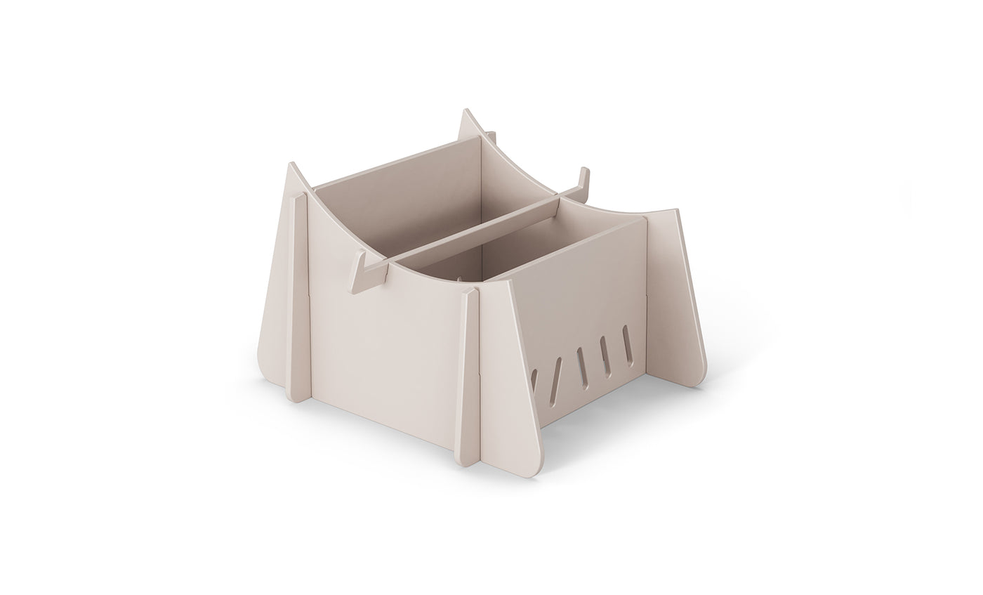 The Signature Chaise Riser by Ledge Lounger is a beige, foldable cardboard cat house with a contemporary design. It features four triangular sides, ventilation slits, and an arched roof opening, offering a cozy outdoor space for cats.